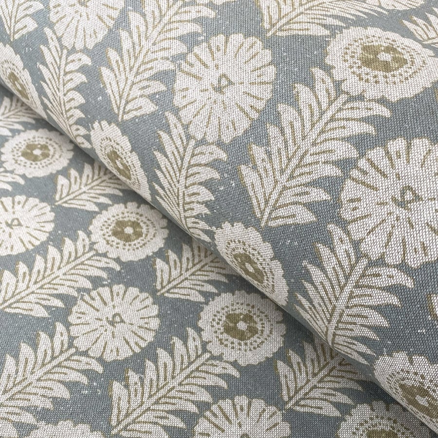 A folk-inspired block print style design with a stylised floral motif in duck egg. A versatile mid scale design suitable for curtains and blinds.