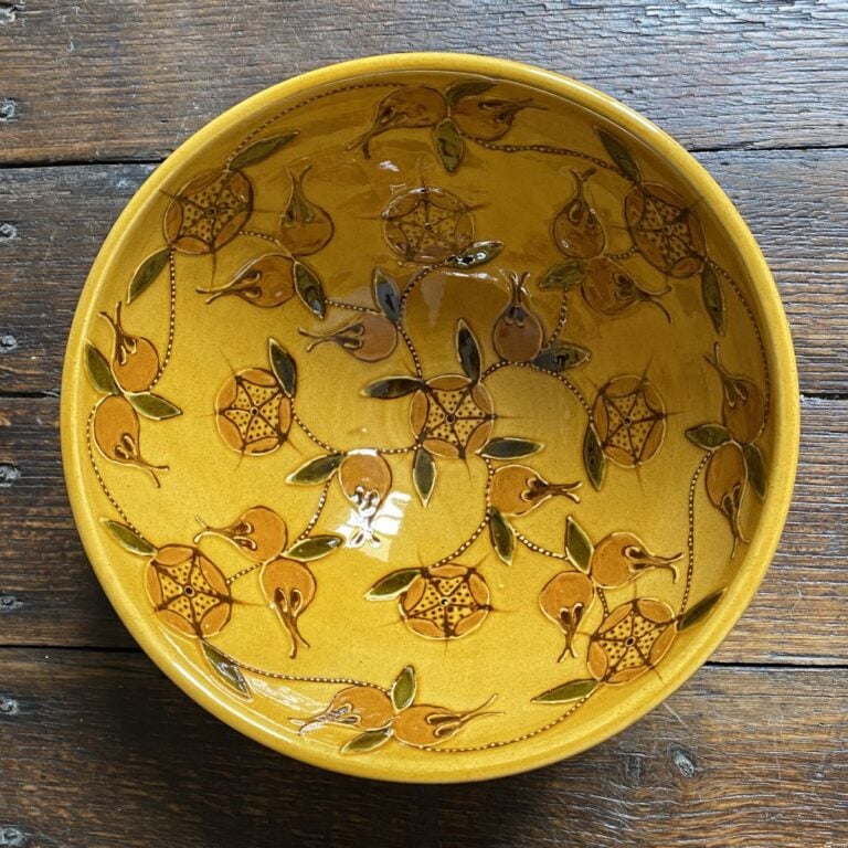Top view of Carole Glover slipware bowl decorated with stylised medlar fruits