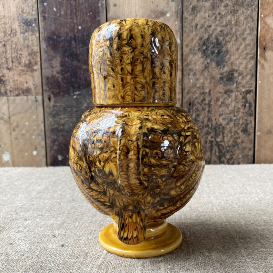 Carole Glover slipware glazed Ozzy Owl against a wooden background