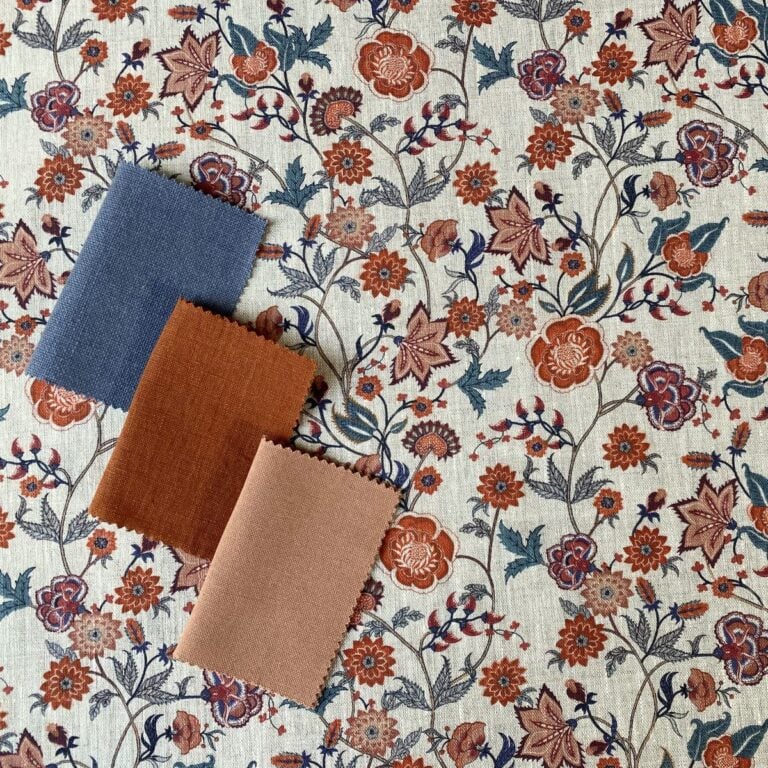 Melody Linen Print fabric in teal & orange on a roll