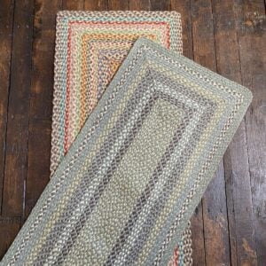 Flatlay of a pair of braided jute runners lying on a wooden floor
