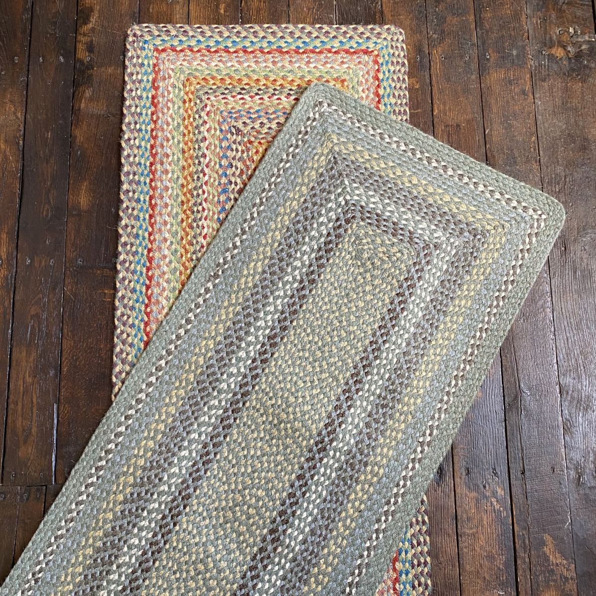 Flatlay of a pair of braided jute runners lying on a wooden floor