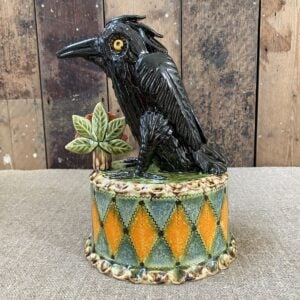 Ceramic slipware black crow on a patterned plinth by Paul Young