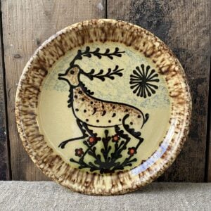 Ceramic slipware plate with stag design on cream base by Paul Young