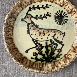 Ceramic slipware plate with stag design on cream base by Paul Young