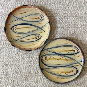 Pair of Jennifer Hall cream glazed side plates on cream backcloth