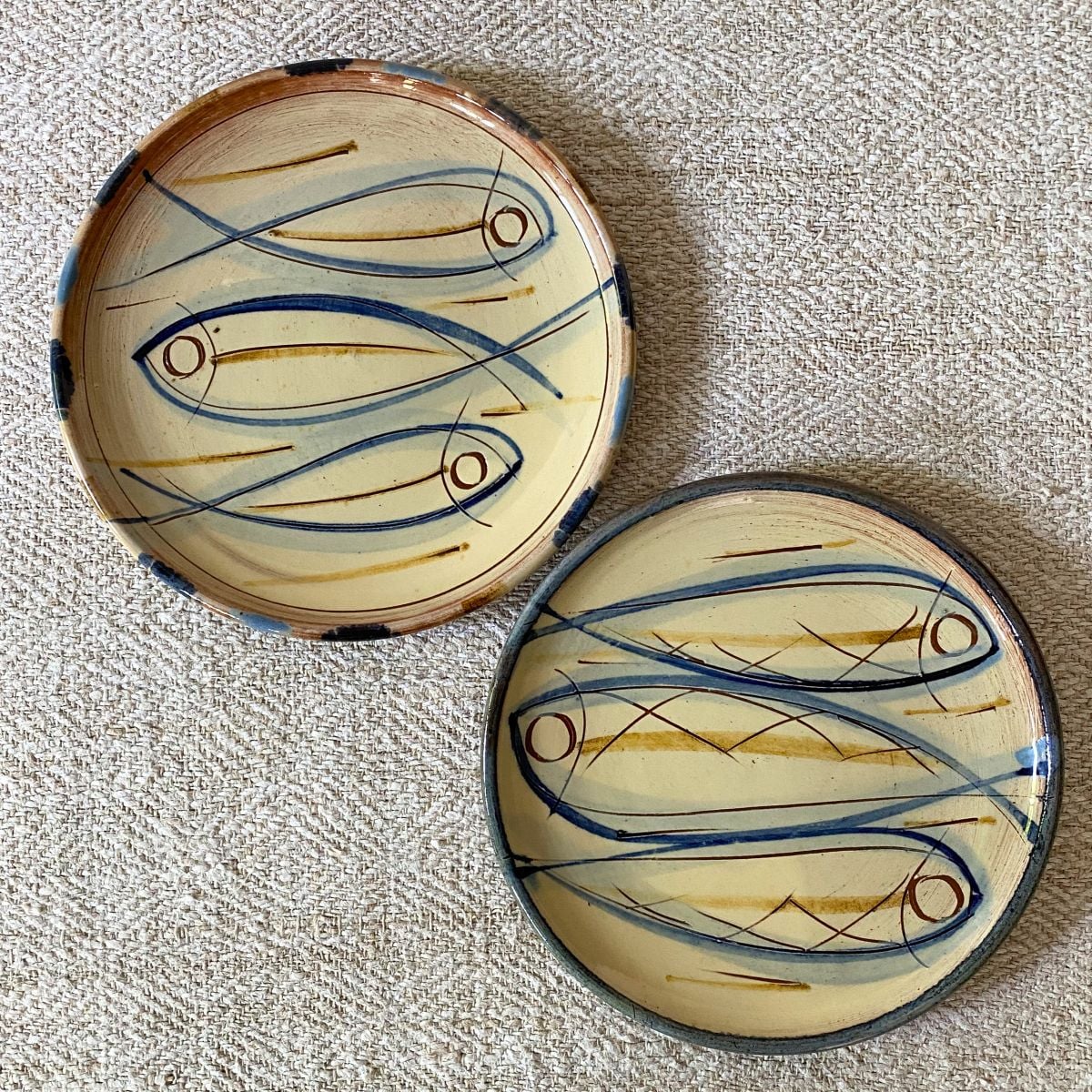 Pair of Jennifer Hall cream glazed side plates on cream backcloth