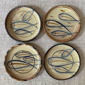 Four Jennifer Hall cream glazed side plates on cream backcloth