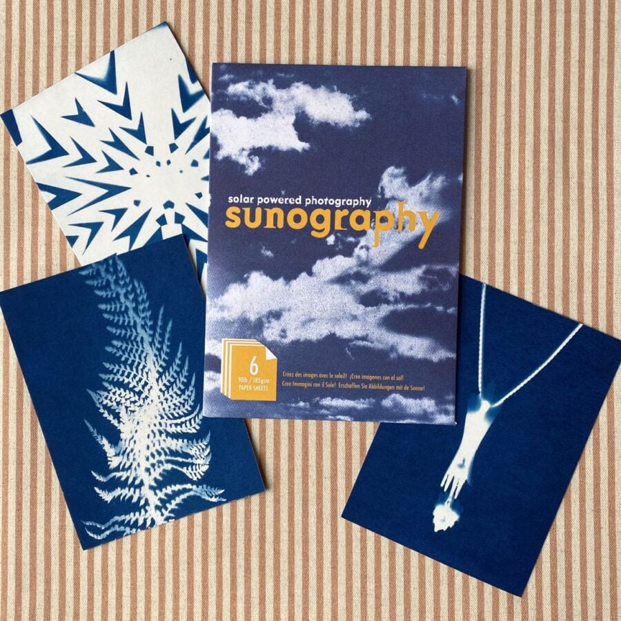 Cyanotype Sunography papers with examples on striped backcloth