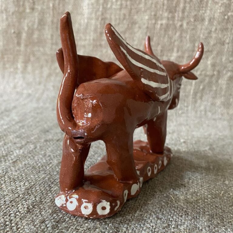 Emma Carlow winged bull pottery whistle against fabric background