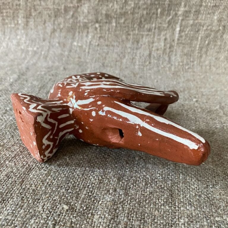 Emma Carlow bird pottery whistle against fabric background