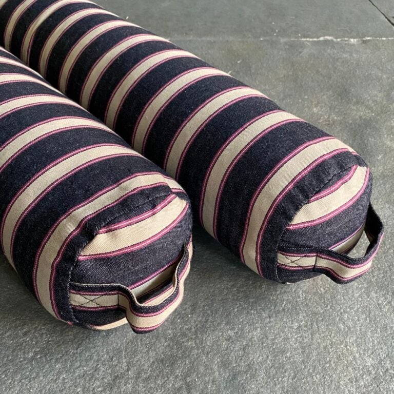 Pair of Striped Draught Excluders on a grey stone floor