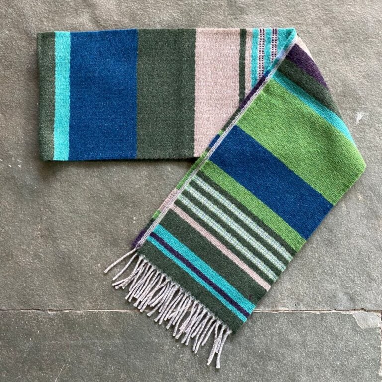 Wallace + Sewell striped wool scarf on a stone floor