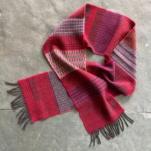 Wallace + Sewell striped wool scarf in a loop on a stone floor