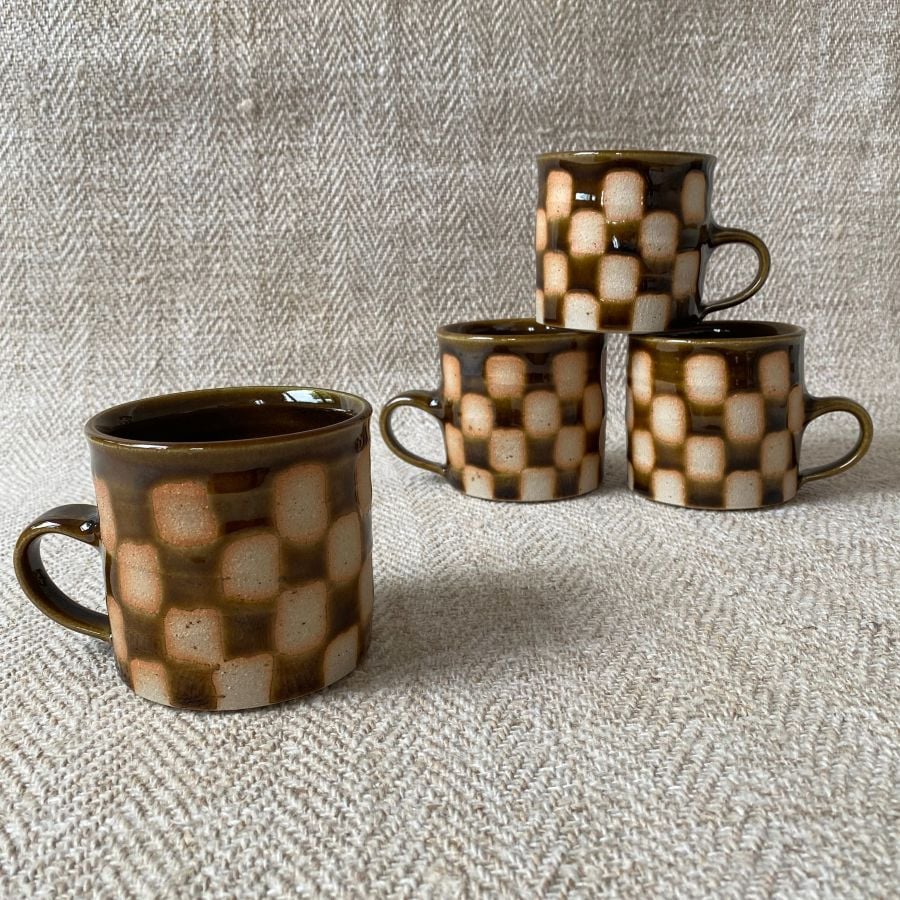 A striking mug with checked design by Norwich potter, Edmund Davies. 