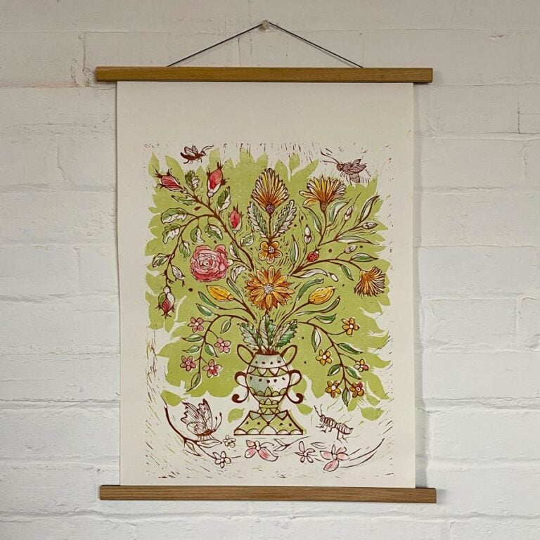 Jen Whiskerd hand coloured lino print on a white wall