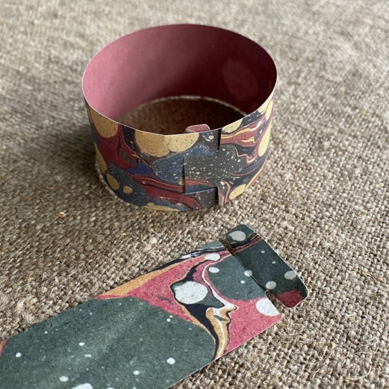 Marbled paper chains on a cloth background