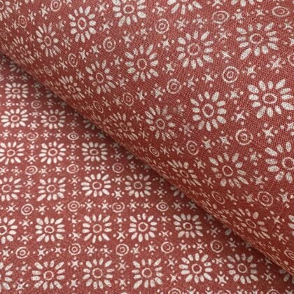 Fabric roll with red, small scale daisy pattern