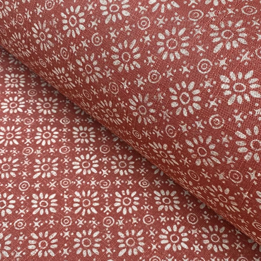 Fabric roll with red, small scale daisy pattern
