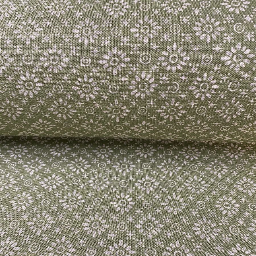 Fabric roll with green, small scale daisy pattern