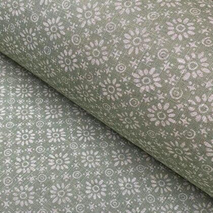Roll of fabric with a sage green floral design