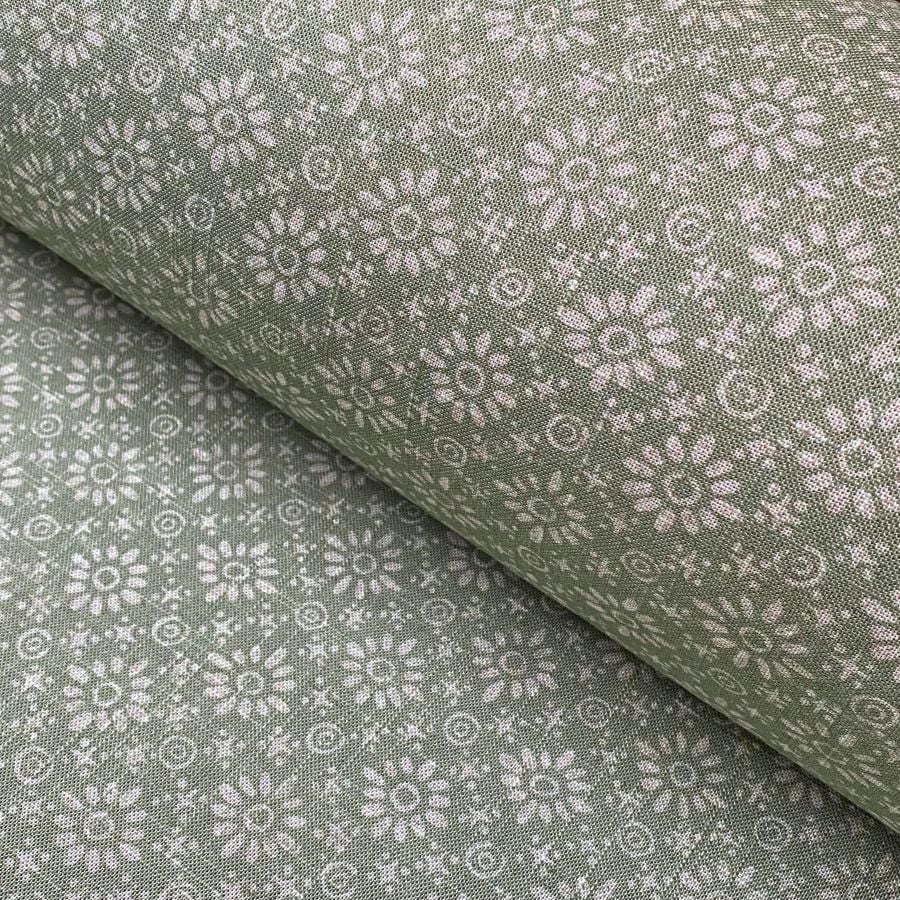 Roll of fabric with a sage green floral design