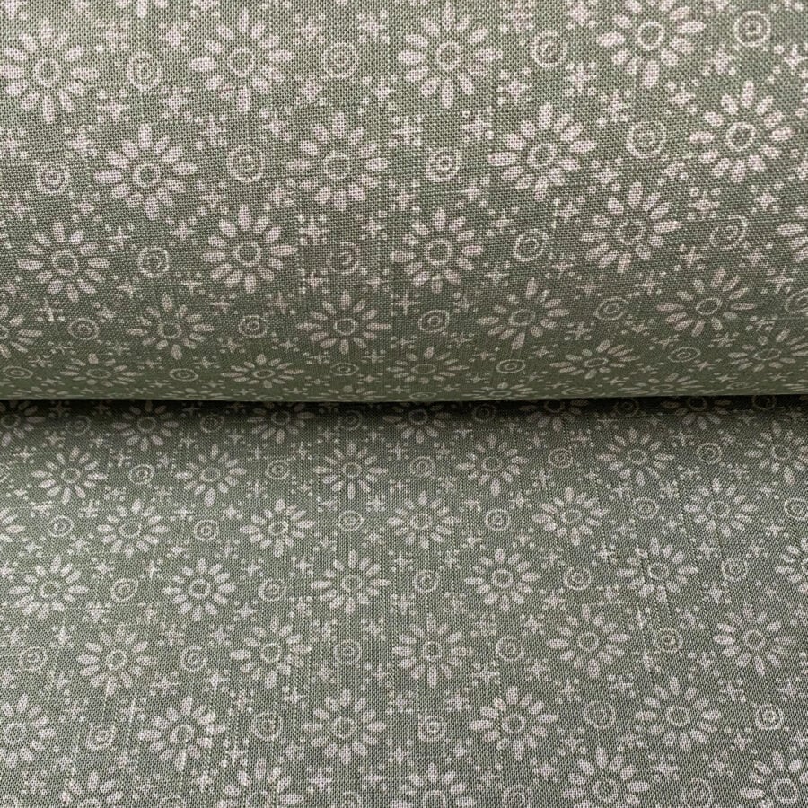 Roll of fabric with a sage green floral design